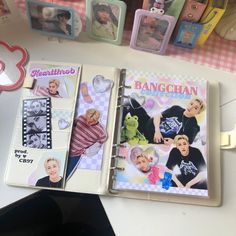 an open planner book with pictures of people on it and the words hangin'in front of them