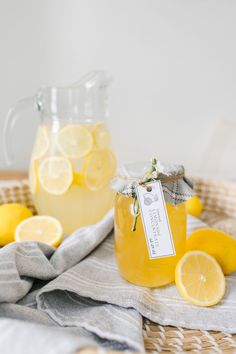 some lemons are sitting on a cutting board next to two glasses and a knife