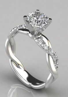 a diamond engagement ring with an intricate twist design