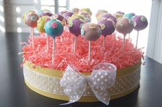 cake pops are arranged on sticks in a basket