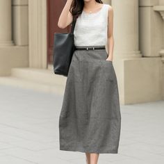 "The skirt's fabric showcases the characteristic linen texture, with visible lines that add depth and interest to the design. This skirt is perfect for both formal and casual occasions, effortlessly blending comfort with style. DETAIL * 100% linen  * No lining * Two front pockets * Back elastic waist * Midi calf length * Bubble skirt * Wash by hand or machine with cold water * Perfect for Spring, spring skirt outfit, casual wear outfit MODEL SIZE Height 170 cm (5′7″)  Bust 80 cm (31.5\")  Waist Grey A Line Skirt Outfit, Summer A-line Maxi Skirt With Pockets, Summer Office Midi Bottoms, Linen Maxi Skirt With Pockets For Work, Relaxed Fit Maxi Skirt For Summer Office Wear, Spring A-line Maxi Skirt With Pockets, Linen A-line Skirt For Workwear, A-line Linen Skirt For Work, Summer Office Skirt With Lining