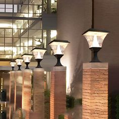 several lamps are lit up on the outside of a building