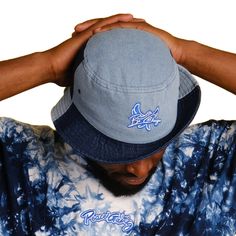 The world only changes with your example not your opinion! BE CHANGE our premium embroidered denim bucket hat. Available in black or a two tone blue colorway. Here’s an accessory that’ll become your main outfit piece. This trendy, comfortable, and versatile bucket hat will work for all kinds of outfits—casual, sporty, and streetwear. - Features Flat Embroidery • 100% cotton • 2 sewn eyelets on each side of the hat • Poplin sweatband • One size fits most Casual Bucket Hat With Embroidered Logo And Short Brim, Casual Bucket Hat With Embroidered Logo, Casual Brimmed Bucket Hat With Embroidered Logo, Blue Casual Bucket Hat With Curved Brim, Casual Blue Bucket Hat With Curved Brim, Blue Bucket Hat For Streetwear, Casual Blue Bucket Hat, Medium Wash Cotton Bucket Hat With Short Brim, Blue Denim Bucket Hat With Short Brim