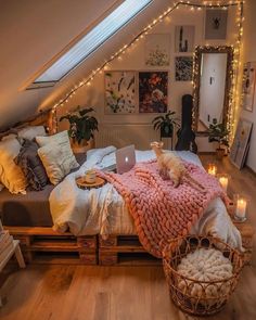 a room with a bed, pillows and blankets on it