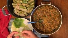 two pans filled with food sitting on top of a table next to each other