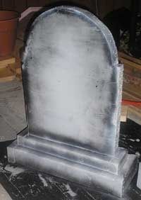 a tombstone sitting on top of a black table