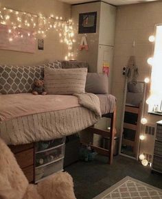 a dorm room with lights strung above the bed