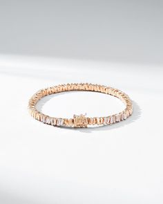 Crafted in 18-karat gold, this tennis bracelet incorporates our beloved baguette diamonds unevenly set while interchanging them with sections of gold all the way around. We love this piece for its seamless design and everyday wearability. The perfect baguette tennis bracelet to instantly elevate any outfit, casual or formal. Details 18k yellow gold, rose gold or white gold 2.00 carats of white diamond baguettes Bracelet measures 7" inches in length Box clasp with safety lock fastening 5mm width Modern Tennis Bracelet With Baguette Diamonds And Cubic Zirconia, Modern Baguette Diamond Bracelets For Anniversary, Rose Gold Bracelets With Baguette Diamonds, Timeless Baguette Cut Jubilee Tennis Bracelet, Timeless Everyday Luxury Tennis Bracelet With Baguette Diamonds, Elegant Baguette Cubic Zirconia Tennis Bracelet, Timeless Baguette Cut Tennis Bracelet, Fine Jewelry Rose Gold Diamond Bracelet With Baguette Cut, Rose Gold Baguette Cut Diamond Bracelet