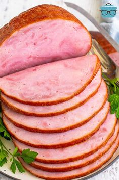 sliced ham on a plate with parsley