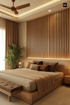 a large bed sitting under a ceiling fan in a bedroom