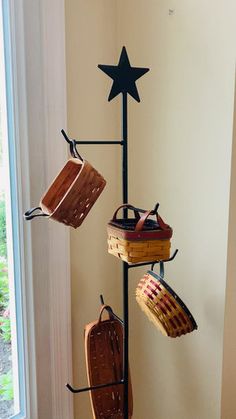 three baskets are hanging on a pole with a star above them and one basket is in the middle