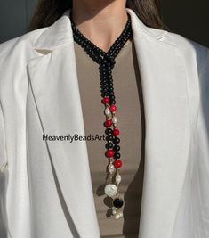 🪸Explore the timeless elegance of our Y-style multistrand necklace, adorned with Onyx, Red Coral, and lustrous Freshwater Pearls.   🐚 This statement piece is perfect for weddings as a guest or as a heartfelt gift. Handcrafted with care, each natural stone is carefully selected to create a harmonious blend of colors and textures, ensuring a unique and striking accessory. Whether you're seeking to elevate your ensemble with a touch of sophistication or searching for a meaningful present, our necklace combines artisan craftsmanship with timeless beauty.      🔮Discover the perfect balance of style and versatility with this exquisite gem. HeavenlyBeadsArt🧿 Elegant Long Red Necklace, Elegant Red Long Beaded Necklace, Elegant Long Red Beaded Necklace, Elegant Black Lariat Beaded Necklace, Elegant Red Long Necklace With Round Beads, Luxury Multi-strand Necklace For Gift, Elegant Multi-strand Lariat Necklace, Elegant Double Strand Beaded Necklace As Gift, Elegant Double Strand Beaded Necklace Gift