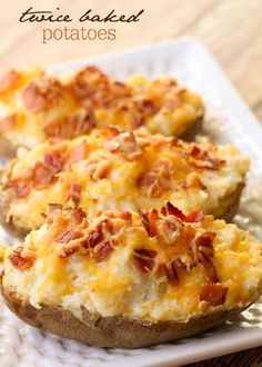 baked potatoes topped with bacon and cheese on a white plate