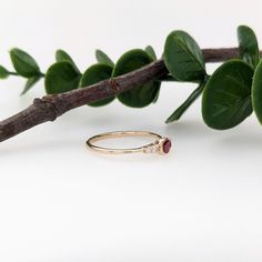 A dainty east west ring is perfect for the minimalist in your life or for giving someone their first piece of jewelry :) This ruby presents a mixture of red hues which is perfectly accentuated by two diamonds on each side. The slim yellow gold shank provides a lightweight, effortless look! This ring is made with solid 14K Gold and natural Earth mined SI / G-H diamonds. As listed, this ring is ready to ship. If you're interested in purchasing this setting with a different center stone please mess Dainty Oval Birthstone Ring For Everyday, Minimalist Oval Ruby Ring For Anniversary, Minimalist Oval Stackable Birthstone Ring, Minimalist Oval Ruby Wedding Ring, Dainty Oval Ruby Ring In 14k Gold, Minimalist 14k Gold Oval Ruby Ring, Dainty Oval Stackable Rings With Simple Design, Dainty Oval Birthstone Ring, Minimalist 14k Gold Oval Birthstone Ring