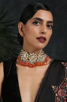 Intricate 22k Gold plated kundan choker necklace based on copper alloy. Necklace Size - 14 inches. Closure - Adjustable dori. DETAILS -100% top Quality -Faux glass polki -22K gold plated silver copper alloy. -Handcrafted in our all girls workshop in Paisley Pop Studio, Jammu and Kashmir Style Tip - This traditional necklace set with a modern update is set to take you through weddings and festivities in style. Perfect accessory for the woman who likes to stand out from the crowd. Pair it with any Orange Temple Jewelry For Gifts, Orange Temple Jewelry As A Gift, Orange Temple Jewelry Gift, Festive Orange Jewelry For Gift, Festive Orange Jewelry Gift, Traditional Orange Jewelry For Celebration, Fusion Style Meenakari Choker For Festivals, Traditional Orange Jewelry For Diwali, Orange Festive Jewelry For Celebration