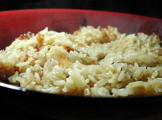 cooked rice in a red bowl on the stove