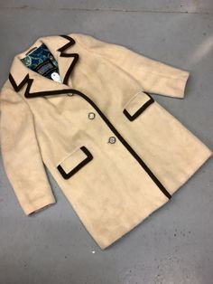 "Classic cut wool, button down LODENFREY jacket made in Austria. Beautiful beige coat with three coin buttons. Two large front pockets with ribbed flap details. Lovely blue floral lining and detailed material inside cuffs also. can be seen in photos. Small mark on right pocket that would likely come out with a dry clean. Otherwise in perfect vintage condition with very little wear. Measurements are as follows... SHOULDER TO SHOULDER 17\" COLLAR TO SHOULDER 6\" SLEEVE LENGTH 24\" PIT TO HEM 25\" Cream Wool Blazer With Lapel Collar, Cream Single-breasted Sport Coat With Lapel Collar, Cream Single Breasted Sport Coat With Lapel Collar, Cream Outerwear With Double Button And Notch Lapel, Beige Winter Outerwear, Cream Outerwear With Double Button Closure And Lapel Collar, Cream Single-breasted Outerwear With Lapel Collar, Cream Wool Single Breasted Blazer, Beige Double-breasted Wool Coat With Buttons