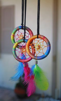 two colorful dream catchers hanging from strings