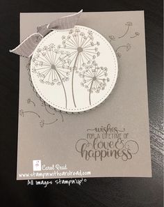 a card with a dandelion design on it