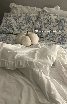 two white pumpkins sitting on top of a bed with the words made my cute bed