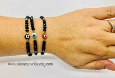 The post is for one individual bracelet. This beautifully handmade bracelet is made of 4mm black rondelle crystal beads, small gold beads with a turkish glass eye bead that is 6mm. They are made with red nylon string and are adjustable to fit most wrists as it has a sliding knot to adjust. These are a great accessory for everyday wear. This bracelet is great for spiritual and evil eye purposes. It is believed that when a person wears or carries an evil eye with them, it guards against misfortune Black Beaded Bracelet With Evil Eye, Black Beaded Evil Eye Bracelet With Round Beads, Protection Bracelet, Sliding Knot, Glass Eyes, Handmade Bracelet, Eye Black, Organza Bags, Gold Beads