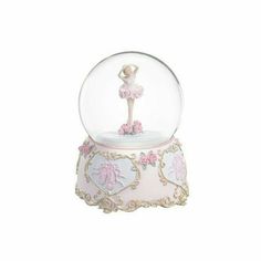 a snow globe with a ballerina on top and pink flowers in the bottom,