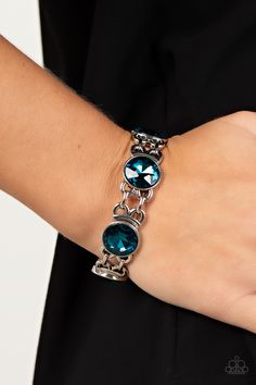 Featuring edgy chain-like fittings, a sparkly series of oversized blue rhinestones are threaded along stretchy bands around the wrist for a dramatic pop of glitz.

Sold as one individual bracelet. Bracelet Blue, Band Bracelet, Jewelry Images, Paparazzi Accessories, Blue Box, Blue Gems, Stretchy Bracelets, Chic Jewelry, Rhinestone Bracelet