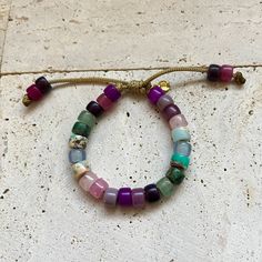 These bracelets and necklaces are a collection based around a rainbow of gemstone pony beads. Add-on stones can be purchases additionally here, please specify if you want your add on strung on your bracelet in the personalization comments. If left blank it will be sent separately: https://www.etsy.com/listing/946252171/bracelet-add-ons?ref=shop_home_active_4 All of my cords are one size fits all. Stones are subject to availability and may be substituted when necessary. Precious gems are formed in different ways and composed of different materials, meaning their appearances vary vastly. Gems may be treated to enrich color. Recommended to be stacked with many! Beaded with love ❤️. Multicolor Natural Stones Friendship Bracelets, Multicolor Bohemian Friendship Bracelets With Gemstone Beads, Multicolor Natural Stones Friendship Bracelets As Gift, Healing Multicolor Hand-strung Friendship Bracelets, Multicolor Natural Stones Friendship Bracelet, Multicolor Gemstone Beads Friendship Bracelet, Multicolor Gemstone Beads Friendship Bracelet As Gift, Spiritual Agate Beaded Bracelets With Colorful Beads, Adjustable Multicolor Natural Stone Friendship Bracelets