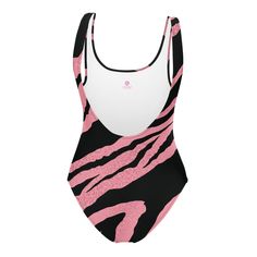 This pink tiger one-piece swimsuit for all figures will bring out your best features. Enjoy the smooth fabric and the flattering design, and show it off by the sea or pool!• 82% Polyester, 18% Spandex• Fabric weight: 6.78 oz/yd² (230 g/m²), weight may vary by 5%• Chlorine-resistant fabric• Cheeky fit with a scoop neckline and a low scoop back• Zig-zag stitching• Double-layer front • Four-way stretch material stretches and recovers on the cross and lengthwise grainsThis product is made especially for you as soon as you place an order, which is why it takes us a bit longer to deliver it to you. Making products on demand instead of in bulk helps reduce overproduction, so thank you for making thoughtful purchasing decisions! Size guide CHEST (inches) WAIST (inches) HIPS (inches) XS 33 ⅛ 25 ¼ 3 Pink Tiger, Swimsuits For All, By The Sea, Spandex Fabric, Zig Zag, Scoop Neckline, One Piece Swimsuit, Double Layer, The Sea