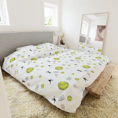 a bedroom with a bed, mirror and rugs on the floor in front of it