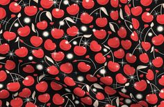 a black background with red cherries and white sparkles on the bottom half of it