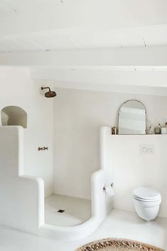 a bathroom with white walls and floors