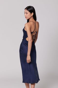 A stunning maxi-length garment that exudes elegance and versatility. This dress features a sophisticated cowl double-lined neckline, elevating its allure and adding a touch of refinement. The adjustable open strappy back offers a unique and customisable element, allowing it to be tied in multiple ways according to personal preference, ensuring a perfect fit and an individualised look. For a modern, contemporary aesthetic, pair the Silk Nova Dress with a matching silk shirt and flats, creating a cohesive and stylish ensemble that is perfect for any casual or formal occasion. Elevate the look by adding heels, guaranteeing that you will be the epitome of refined sophistication at any event, making a lasting impression with every step. Even as the temperature cools, the versatility of the Silk French Navy Blue, French Navy, Dress Silk, Pearl Jewellery Earrings, Contemporary Aesthetic, Independent Designers Fashion, Silk Shirt, Mulberry Silk, Gifts For New Moms