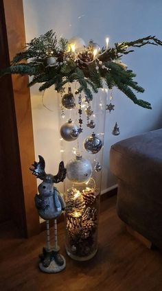 a glass vase filled with ornaments and lights