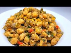 a white plate topped with chickpeas and vegetables