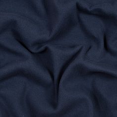 a close up view of a blue fabric textured with thin lines and folds on the surface