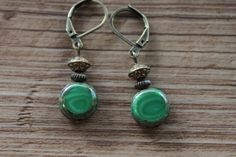 Emerald Green Earrings Czech Glass Earrings Dangle Drop Earrings SMALL EARRINGS Gift for women Color : Emerald green czech glass beads 11mm Finish : Antiqued brass findings Size : Approx 1-3/4 inches including the antique brass lever back Ear wires : Antique Brass lever back Czech Glass Earrings : https://www.etsy.com/shop/NtikArtJewelry?ref=hdr_shop_menu§ion_id=16062218 Thanks for looking Green Hypoallergenic Brass Earrings, Hypoallergenic Green Brass Earrings, Green Adjustable Vintage Earrings, Green Vintage Earrings, Small Dangle Earrings, Emerald Green Earrings, Lotus Earrings, Mixed Metal Earrings, Teardrop Dangle Earrings