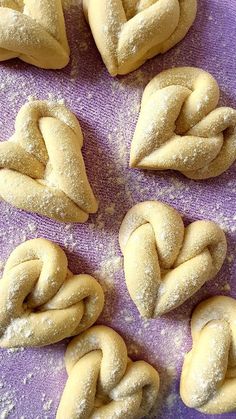 several braided pastries on a purple cloth