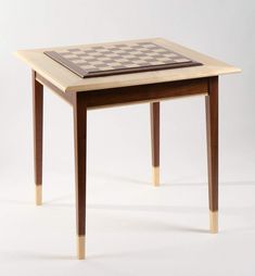 a small table with a chess board on it's top that is made out of wood