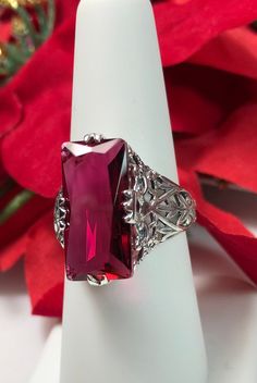 Simulated Ruby Ring Description Intaglio Design#31 MADE TO ORDER Inspired by the intricate Victorian designs of the late 1800s, I now offer this gorgeous filigree Antique reproduction in sterling silver. The lovely ring is set with a flawless 7ct simulated red ruby. The baguette rectangle-cut red ruby color gem is 18mm long by 9mm wide. The ring is 8mm off the finger. The inside of the band is marked 925 for sterling. Notice the intricate and detailed design of the silver filigree setting and ba Classic Red Ruby Jewelry, Classic Red Engraved Jewelry, Classic Red Gemstone Jewelry, Classic Red Jewelry With Lab-created Ruby, Red Victorian Engraved Jewelry, Classic Red Lab-created Ruby Jewelry, Formal Octagon Ruby Jewelry, Red Filigree Jewelry For Formal Occasions, Classic Burgundy Ruby Ring For Formal Occasions