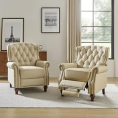 a living room with two chairs and a ottoman