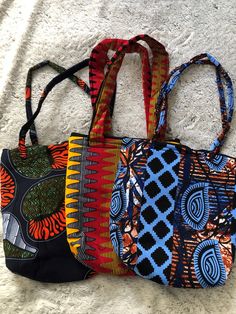 Handmade ethical bags in 100% African cotton fabrics with a zip close top.  Approximate dimensions 32cmH x 30cmW, although there are some natural variations due to being hand-made. Produced by the ARISE women's group in Mbita, Kenya - a group of young mothers and widows who have been trained by PFP in tailoring skills. All profits from sale of this item will be reinvested in training further women in sustainable livelihoods, so that they can earn an income and feed and school their children.  Th African Fabric Accessories, Bright Prints, Diy Sewing Tutorials, Womens Group, Custom Tote Bags, Printed Handbags, Fabric Accessories, African Print Fabric, Easy Sewing Projects