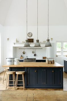 a kitchen with blue cabinets and wooden counter tops