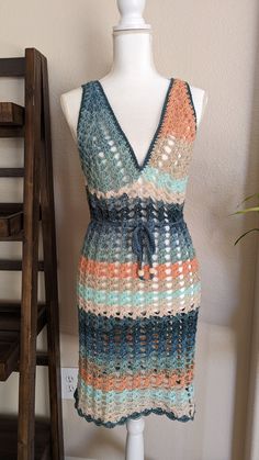 This beautiful variegated crochet mesh dress is perfect for spring/summer. Expertly crafted with a stylish variegated design, this dress is the ideal addition to your warm weather wardrobe. Made with quality materials, it's a timeless piece that will elevate your style while keeping you cool and comfortable. CUSTOM MADE ORDER: Choose the color, size, and material for a unique product. Experience the perfect combination of style and functionality with custom options tailored to your liking. Size: Small/Medium Material: 100% Acrylic Measurements in inches: 35" shoulder to bottom hem, 25" neckline to bottom hem, 18" armhole to armhole, 24" armhole all around, 24" front neckline.  Care Details: Machine wash on gentle cycle and hang dry. Spring Crochet Trim Beach Cover-up Dress, Spring V-neck Crochet Beach Dress, Spring Crochet Lace Dress For Beach Cover-up, Multicolor Crochet Top For Spring Beach Cover-up, Vacation Crochet Lace Dress With Open Knit, Multicolor Crochet V-neck Dress, Beachy Lace Dress For Spring, Beachy Spring Lace Dresses, Beachy Lace Dresses For Spring