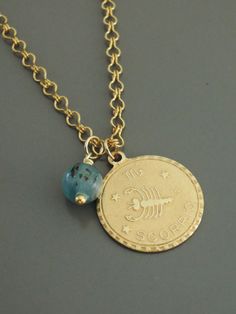 "This is such a fabulous Scorpio necklace! A vintage golden brass pendant with a gorgeous Aquamarine birthstone bead. The vintage brass chain is exquisite. I do have all 12 signs. Chloe says, \"Wear it and feel fabulous!\" The pendant is 1\" round. If you would like the necklace a different length let me know. Thanks for visiting Chloe's" Handmade Bronze Brass Charm Necklaces, Spiritual Gold Birthstone Jewelry, Yellow Gold Birthstone Brass Jewelry, Yellow Gold Brass Jewelry With Birthstone, Yellow Gold Birthstone Jewelry In Brass, Handmade Gold Spiritual Birthstone Necklace, Handmade Spiritual Gold Birthstone Necklace, Gold Birthstone Jewelry For Jewelry Making, Personalized Brass Amulet Jewelry