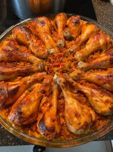 a large platter filled with chicken wings on top of a counter