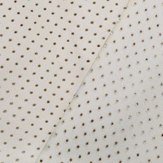 white and brown polka dot fabric close up