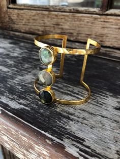 21 ct gold plated brass. Labradorite semi-precious stone Free size - Designed by our Turkish designer. Handcrafted with great care. Bohemian Gold Cuff Bracelet With Gemstone, Gold Labradorite Bracelet As Gift, Gold Cuff Bracelet With Natural Stones, Bohemian Gold Bangle With Gemstone, Gold Bohemian Bangle With Gemstone, Bohemian Gold Cuff Bracelet With Natural Stones, Gold Bohemian Cuff Bracelet With Natural Stones, Gold Labradorite Bracelets With Natural Stones, Gold Labradorite Bracelet With Natural Stones