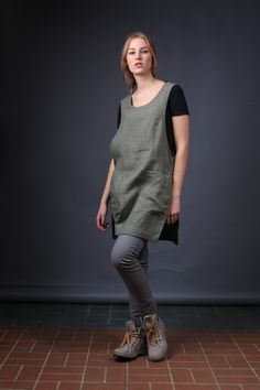 "Oeko-tex Standard certified 100% linen apron offers comfort and quality. Side pockets for tools or kitchen utensils make this apron perfect for everyday use. We have a variety of lengths and styles to suit your needs. Keep looking crisp! Details: *Pockets: patch no flap *Colour shown: olive green *Model is wearing size M *Medium weight *Not-ironed (and no need to) *Handmade by @LinenCloud Easy care: - Machine wash cold - Wash seperately or with similar colours - Do not bleach - Tumble dry low - Linen Apron Pinafore, Japanese Style Apron, Linen Apron Dress, Apron Pinafore, Linen Pinafore, Pinafore Apron, Linen Tunic Dress, Sewing Aprons, Aprons Patterns