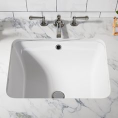 a white sink sitting on top of a marble counter